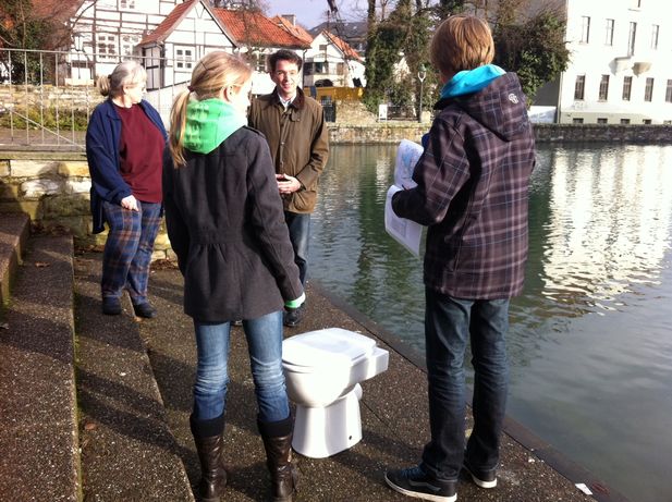 Schüler des Aldegrevergymnasiums erklären dem Bürgermeister der Stadt Soest, wie viele Toilettenspülungen man mit dem Wasser aus dem Großen Teich durchführen könnte